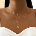 Collar de tres colgantes con circonita dorada