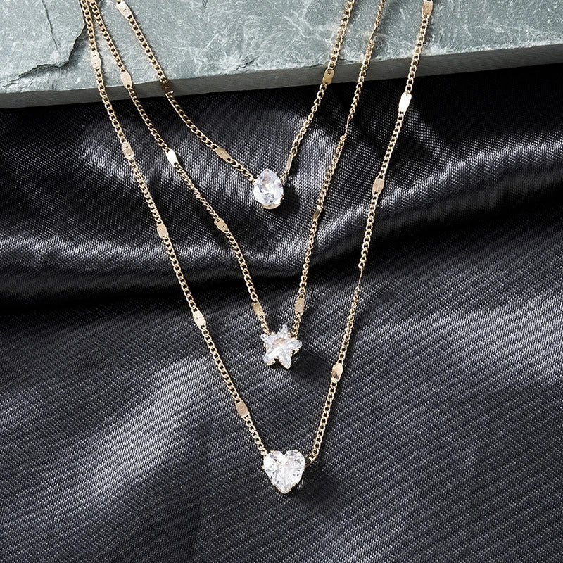 Collar de tres colgantes con circonita dorada