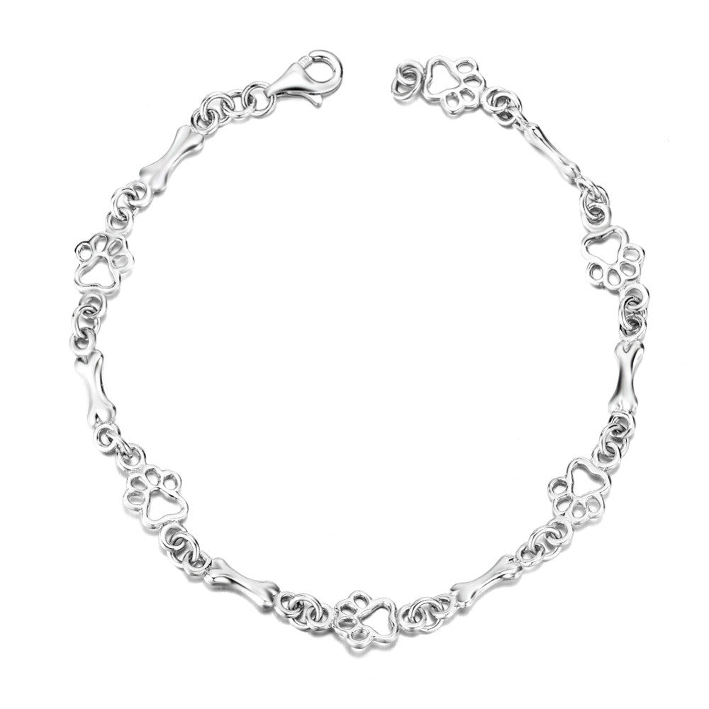 Pulsera con charms de huella y hueso en plata