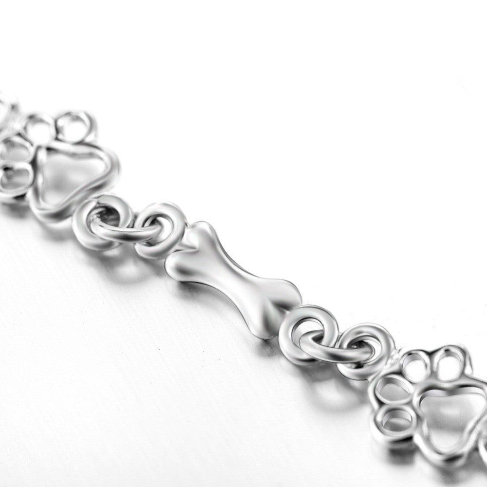 Pulsera con charms de huella y hueso en plata